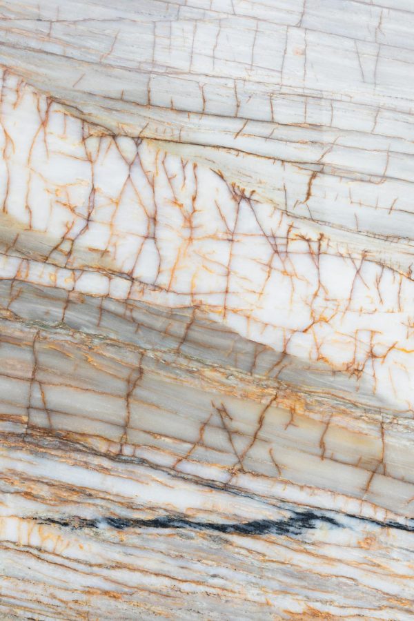 Detailed vertical shot of marble with intricate cracks and natural pattern.